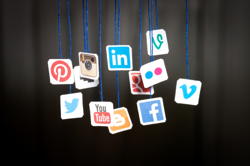 Popular social media website logos printed on paper and hanging